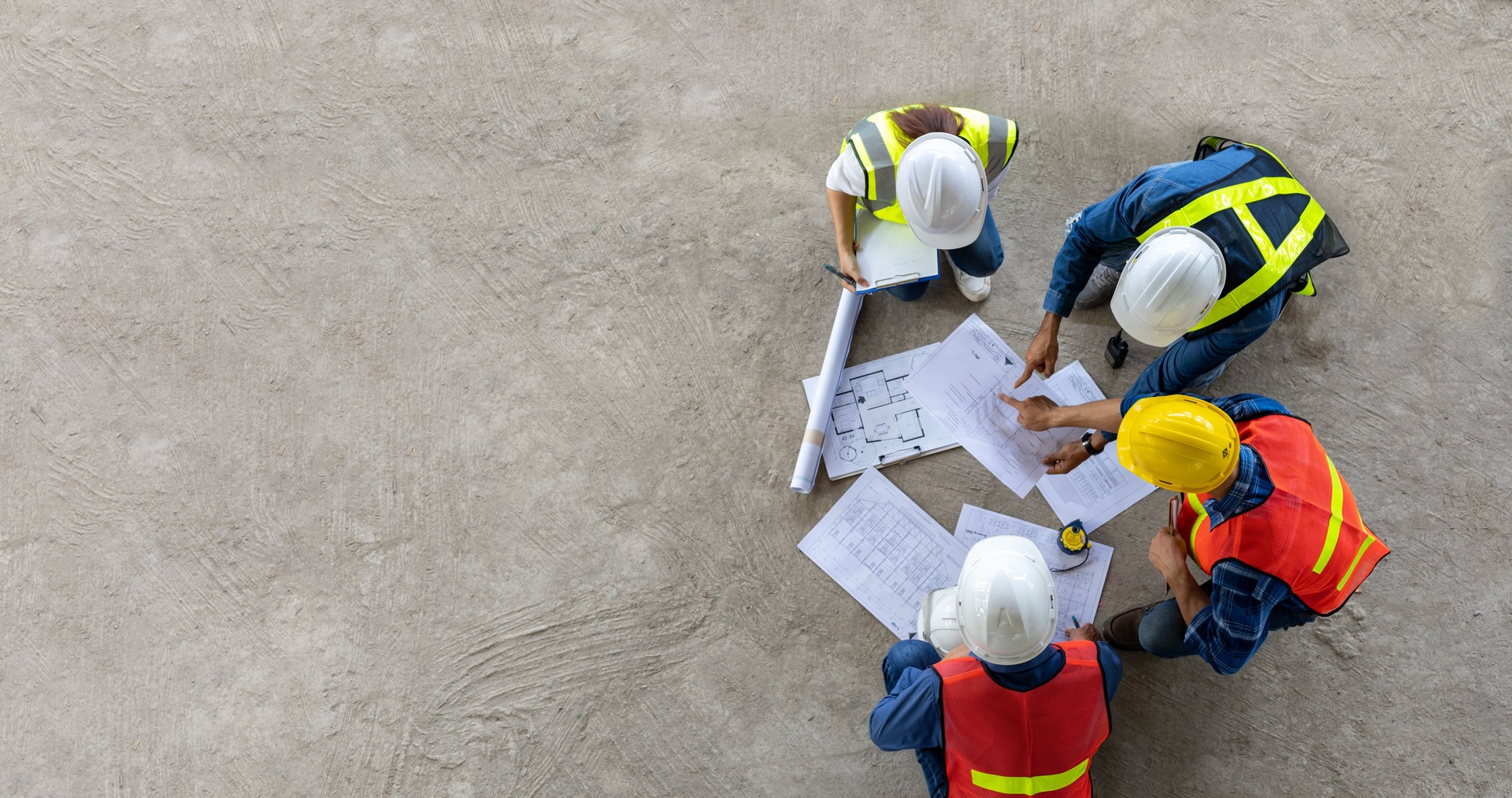 Top view of engineer, architect, contractor and foreman meeting at the construction building site with floor plan for real estate development project industry and housing timeline concept